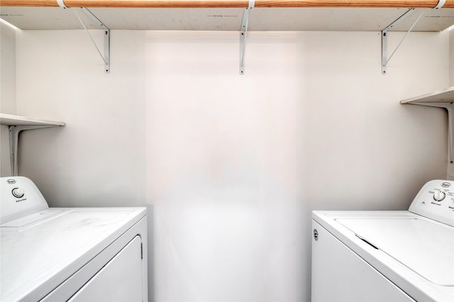 Laundry area with washer and clothes dryer | Image 14