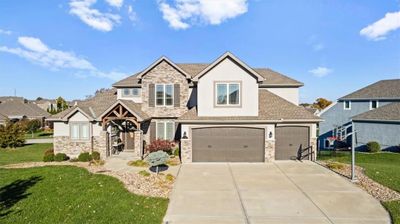 View of front of home with a garage and a front lawn | Image 1