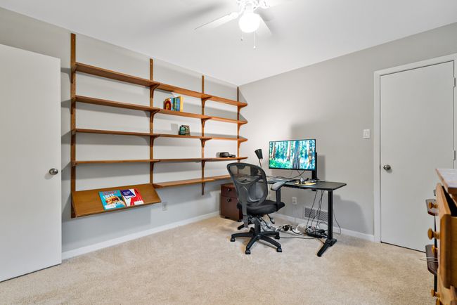 Carpeted bedroom featuring ceiling fan and baseboards | Image 23