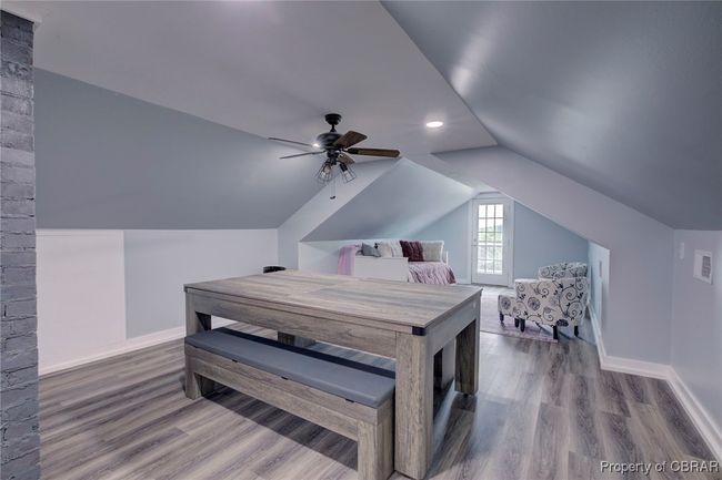 Bedroom with wood-type flooring, vaulted ceiling, and ceiling fan | Image 49