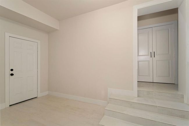 A convenient secondary entrance to the home is located near the versatile final bedroom, providing easy access and added flexibility for guests or family members. | Image 30