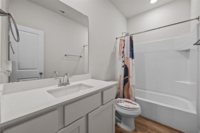 Full bathroom with wood finished floors, toilet, shower / bath combo, vanity, and recessed lighting | Image 24