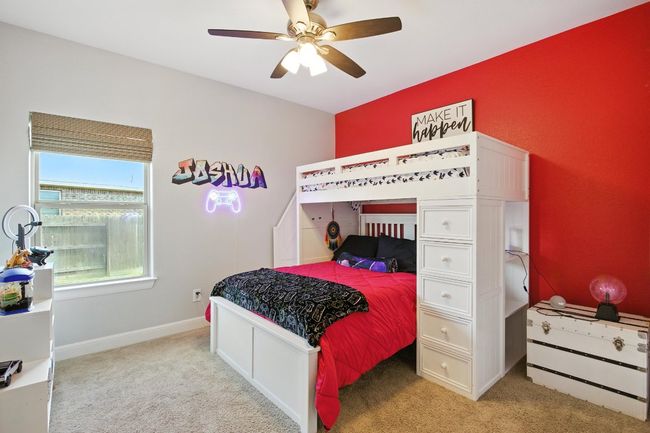 Bedroom with light colored carpet and ceiling fan | Image 24