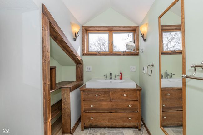 bathroom featuring vanity, lofted ceiling, and baseboards | Image 15