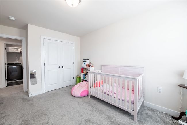 Carpeted bedroom featuring washer / dryer and a closet | Image 26