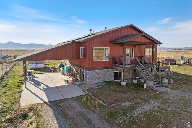 View of front of property with stone siding, a mountain view, and driveway | Image 4