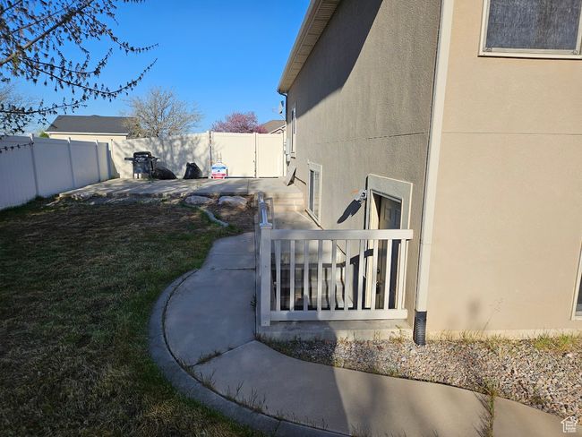 View of side of property with a fenced backyard and stucco siding | Image 79
