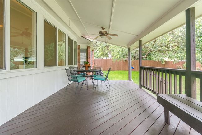 Deck featuring a fenced backyard, outdoor dining space, and ceiling fan | Image 27