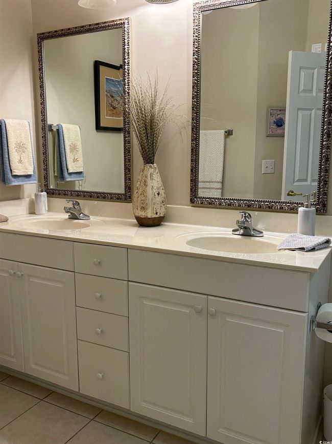Bathroom featuring double vanity, a sink, and tile patterned floors | Image 11