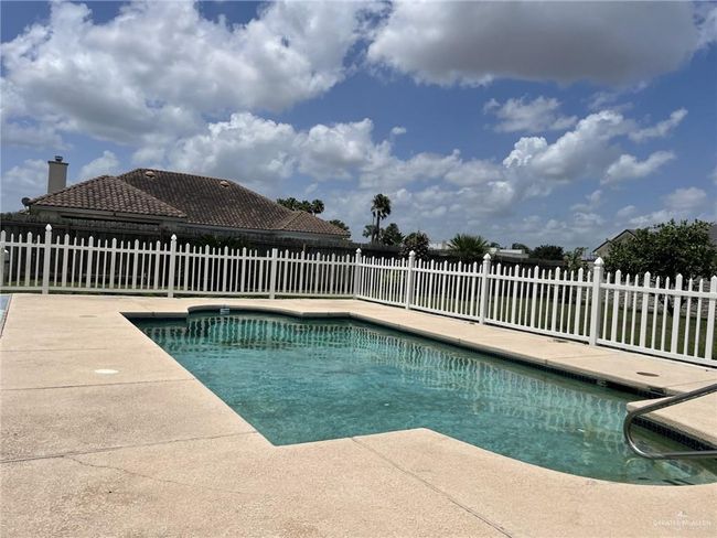 View of swimming pool with a patio | Image 16