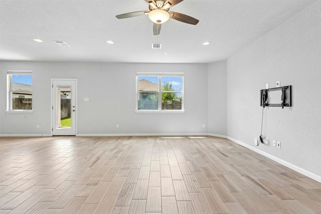 Unfurnished living room with recessed lighting, a ceiling fan, and light wood finished floors | Image 9