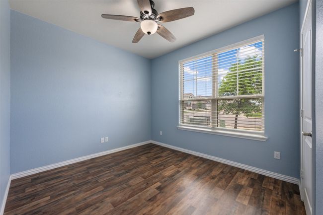 Spare room featuring dark wood finished floors, baseboards, and a ceiling fan | Image 7