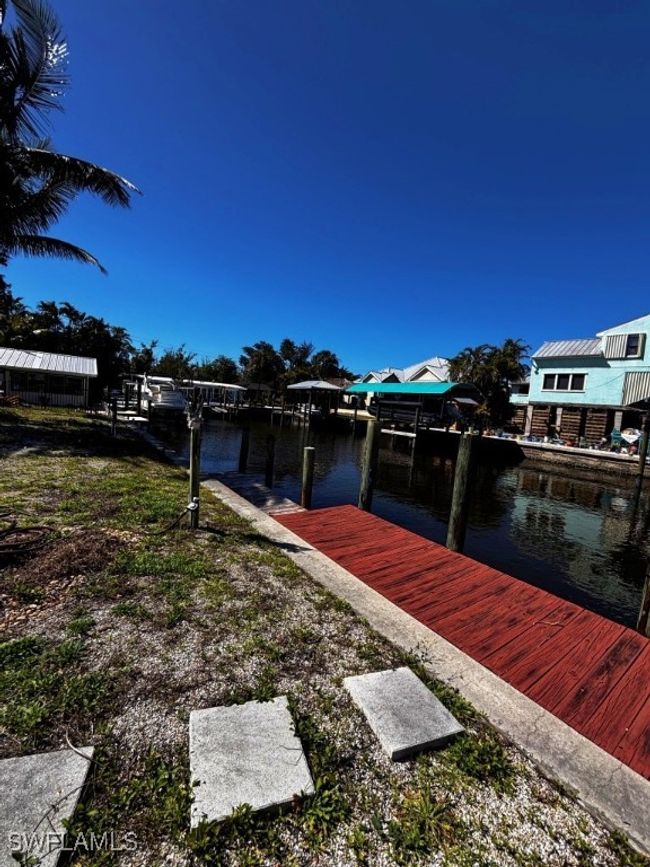 Dock area with a water view and boat lift | Image 27