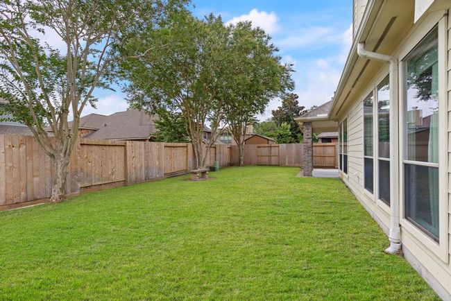 The spacious backyard offers lush green space, mature trees, and plenty of room to play, garden and room for a pool! | Image 22