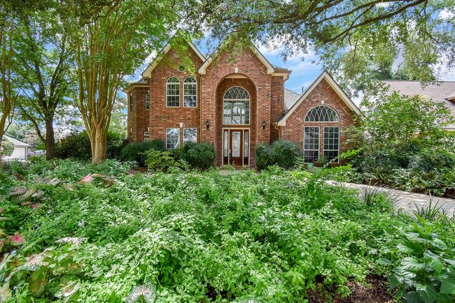 Beautifully manicured front gardens enhance the home's curb appeal. | Image 6