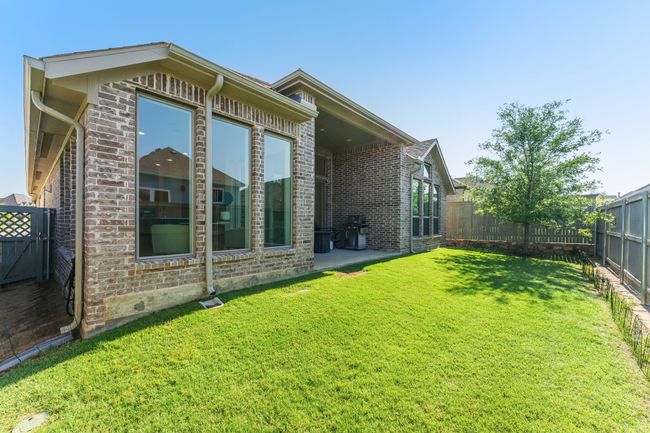 Rear view of property featuring brick siding and a patio area | Image 38