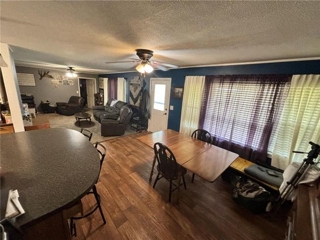 Dining space with laminate flooring and ceiling fan | Image 16