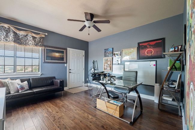 Office area featuring wood-type flooring, and a ceiling fan | Image 35