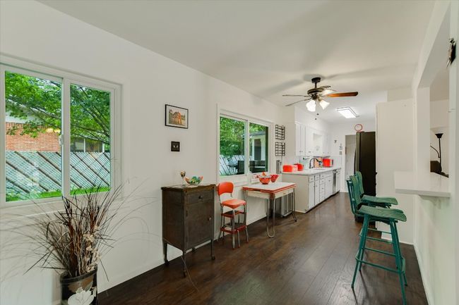 Dining space featuring a ceiling fan, dark wood-style floors, and baseboards | Image 10
