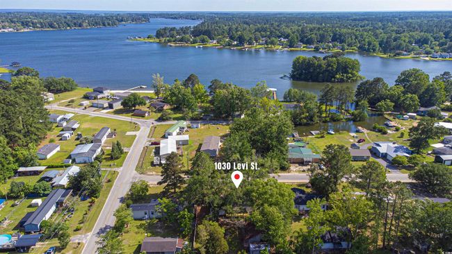 Aerial overview of property's location featuring a forest and a nearby body of water | Image 28