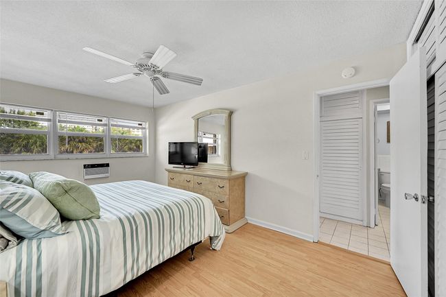 Newer Friedrich Wall AC, Impact Windows and Blinds Included. Primary Bedroom is Furnished with a King Sized Furniture Suite and still has room for a Seating, Reading or Desk Area if needed. | Image 43