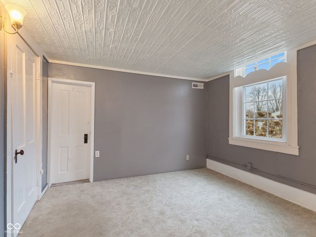 empty room with visible vents, wooden ceiling, ornamental molding, and carpet | Image 20