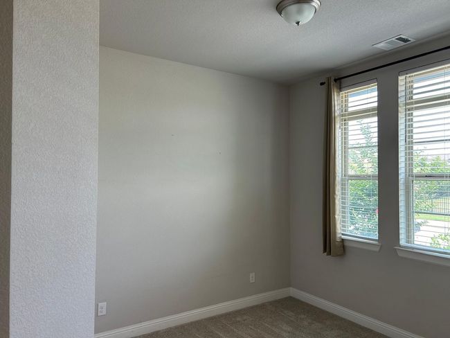 Carpeted empty room featuring baseboards and a textured ceiling | Image 6