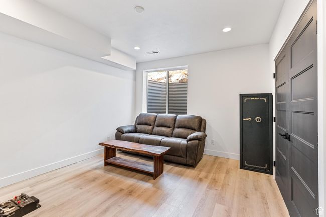 Living area featuring light wood-style floors, baseboards, visible vents, and recessed lighting | Image 30
