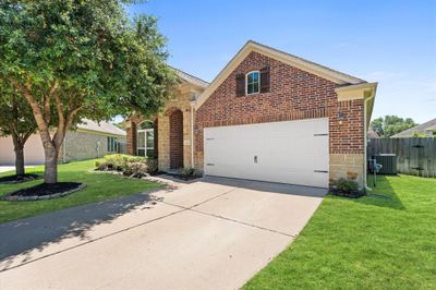 This stunning home has lovely curb appeal, a well-manicured lawn, beautiful landscaping, and a double driveway. | Image 2