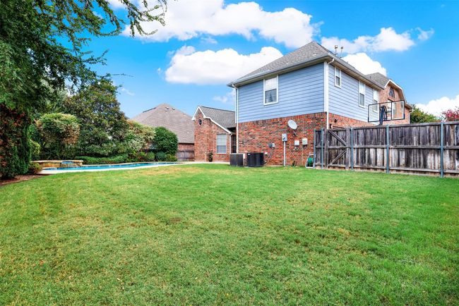Spacious yard features covered patio, swimming pool, mature trees for privacy, plenty of grass & long driveway, perfect for kinds play area | Image 4