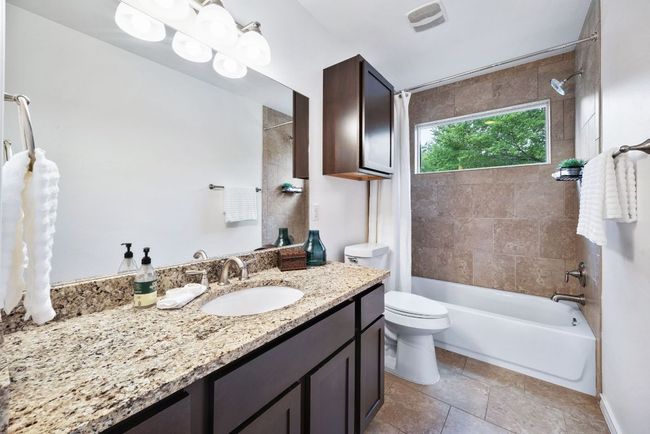 Secondary bedroom features a full bath and granite countertops | Image 32