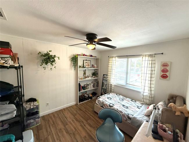 Bedroom featuring wood finished floors, a textured ceiling, and ceiling fan | Image 24