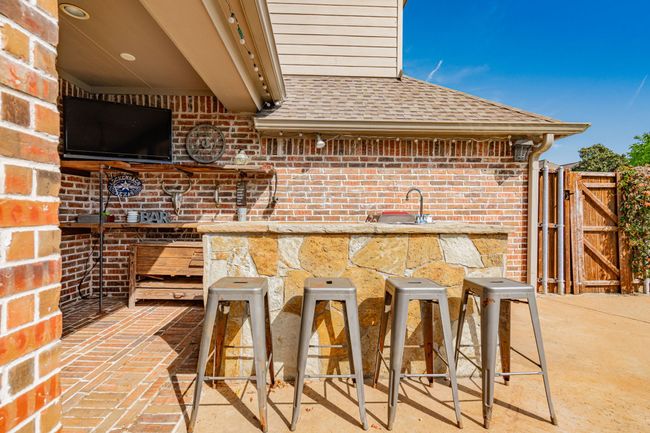 View of patio / terrace with a gate and outdoor dry bar | Image 32
