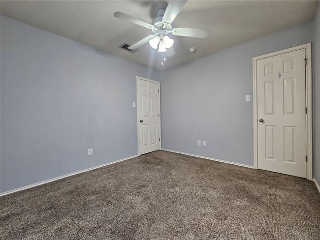 Empty room featuring dark colored carpet and ceiling fan | Image 26
