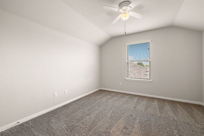 Bonus room featuring vaulted ceiling, carpet flooring, baseboards, and ceiling fan | Image 26