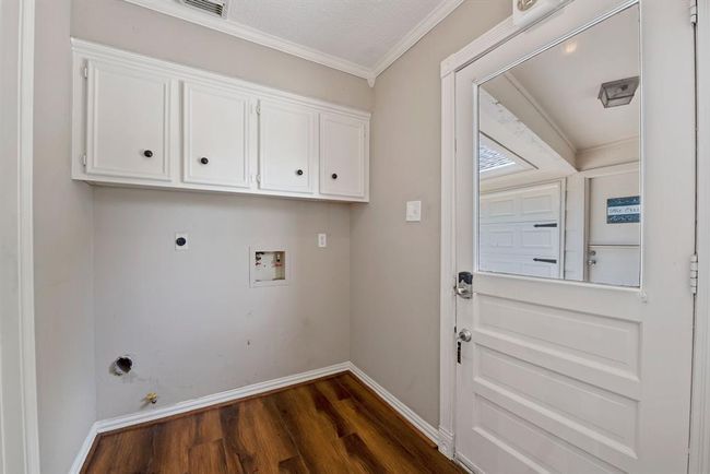 Utility room has access to back yard and garage for unloading groceries and more. | Image 33