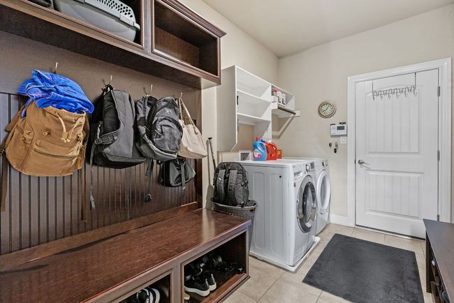 Washroom featuring light tile patterned floors and independent washer and dryer | Image 32