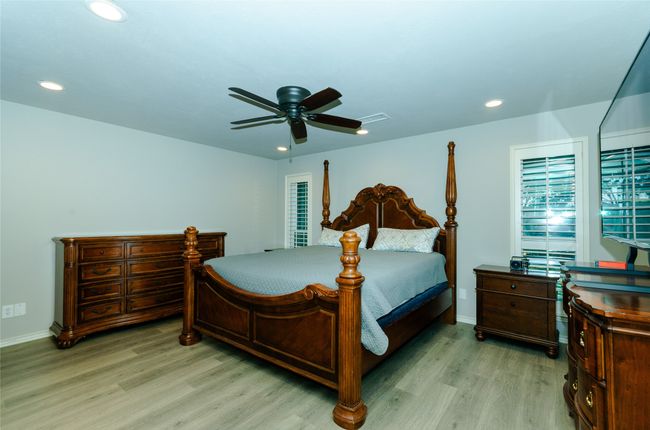 Bedroom featuring light wood-style floors, ceiling fan, and recessed lighting | Image 12