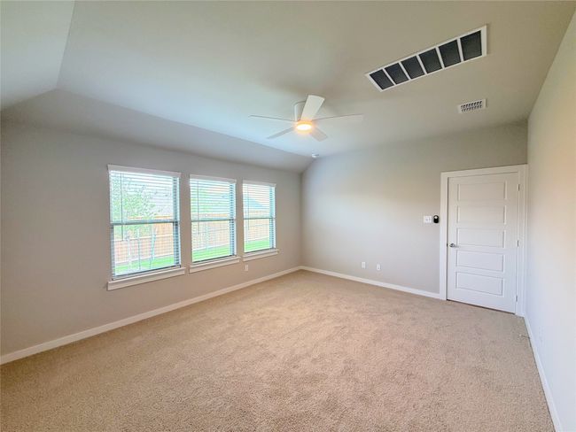 Spare room with a ceiling fan, carpet flooring, baseboards, and lofted ceiling | Image 30