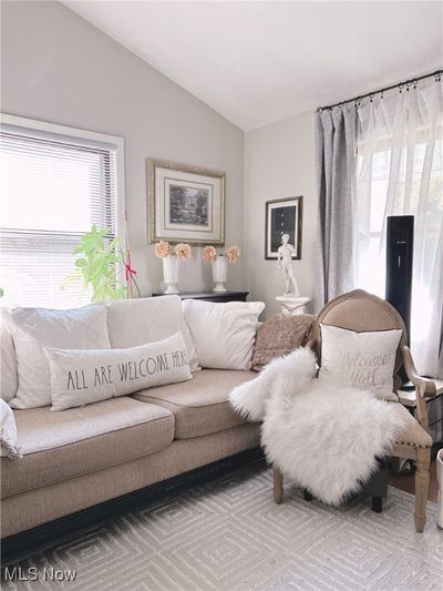 Living room featuring lofted ceiling and wood floors | Image 3