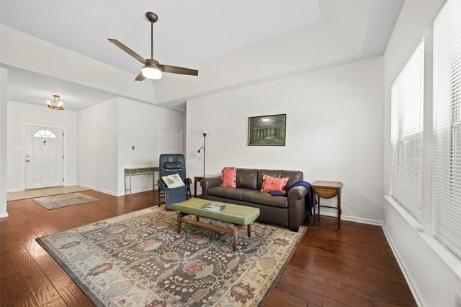 Living area featuring hardwood / wood-style floors and ceiling fan | Image 7