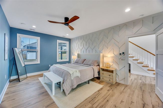Bedroom featuring visible vents, baseboards, recessed lighting, light wood-type flooring, and an accent wall | Image 22