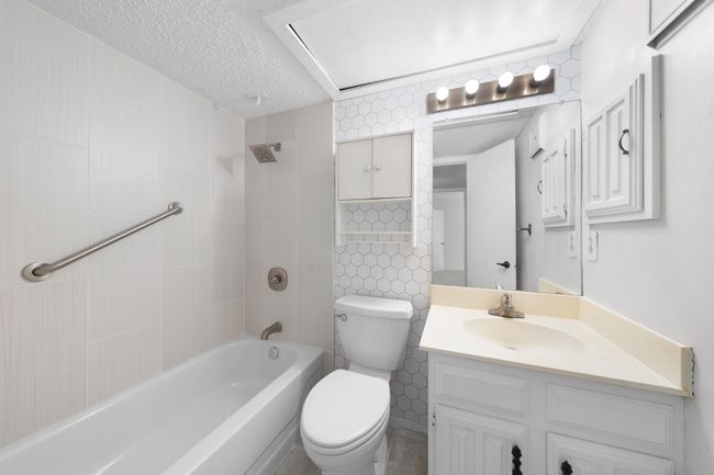 Upstairs updated hall bath serves two secondary bedrooms. | Image 18