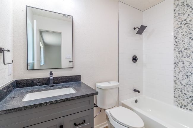 Bathroom featuring toilet, vanity, and bathtub / shower combination | Image 20