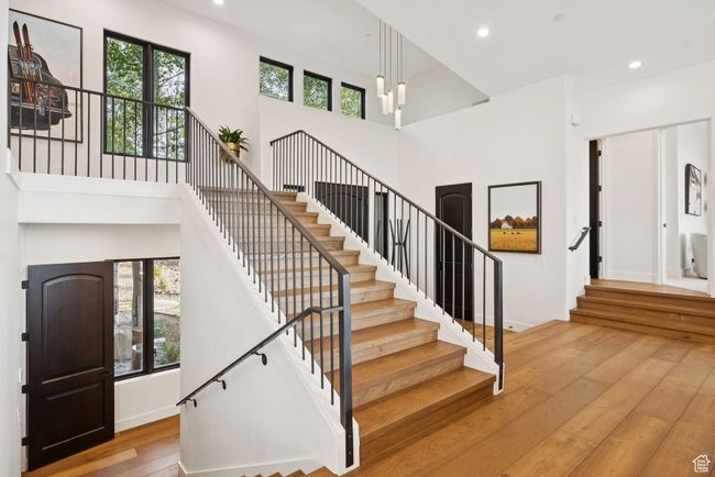 Stairs with hardwood / wood-style flooring, a high ceiling, and recessed lighting | Image 42