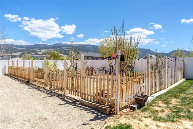 View of yard featuring a fenced backyard and a mountain view | Image 63