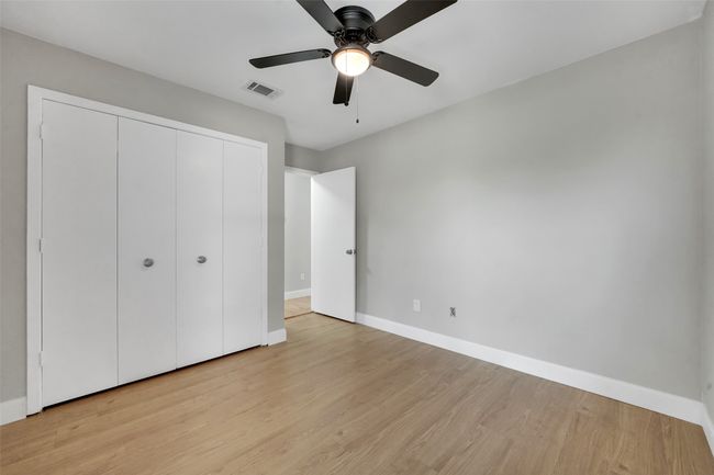 Unfurnished bedroom featuring light wood-style floors, a closet, and ceiling fan | Image 22