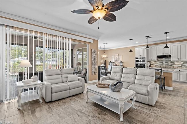 Living room with crown molding, a ceiling fan, baseboards, and recessed lighting | Image 18