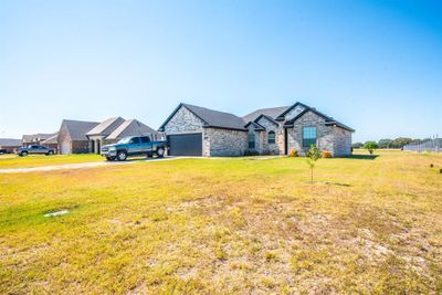 View of front of home featuring a garage and a front yard | Image 3