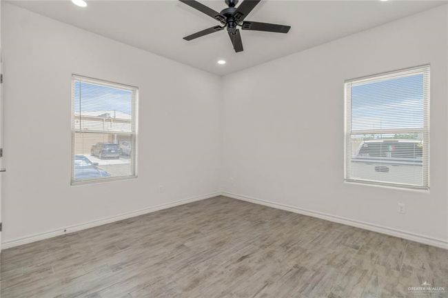 Spare room with healthy amount of natural light, light wood-type flooring, ceiling fan, and recessed lighting | Image 5